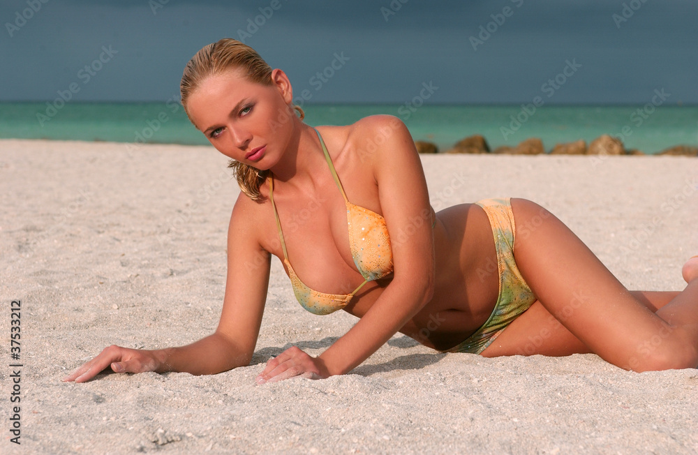 Young beautiful women on the sunny tropical beach in bikini