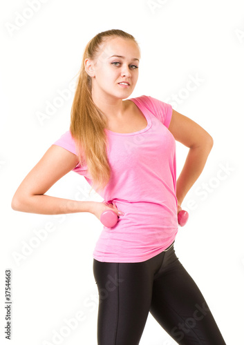 Beautiful smiling girl with free weights in gym