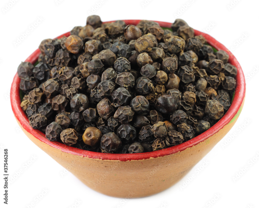 Black peppers on a small clay pot Black peppers on a small clay pot
