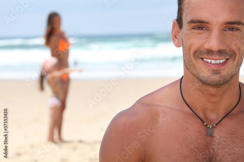 Man at the beach with his family