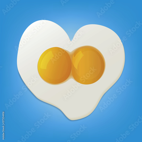 fried eggs In the form of heart on the blue background