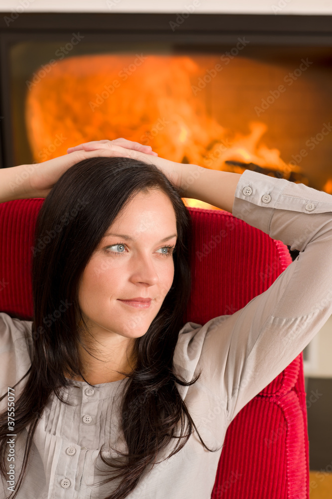 Fototapeta premium Winter home fireplace woman relax red armchair