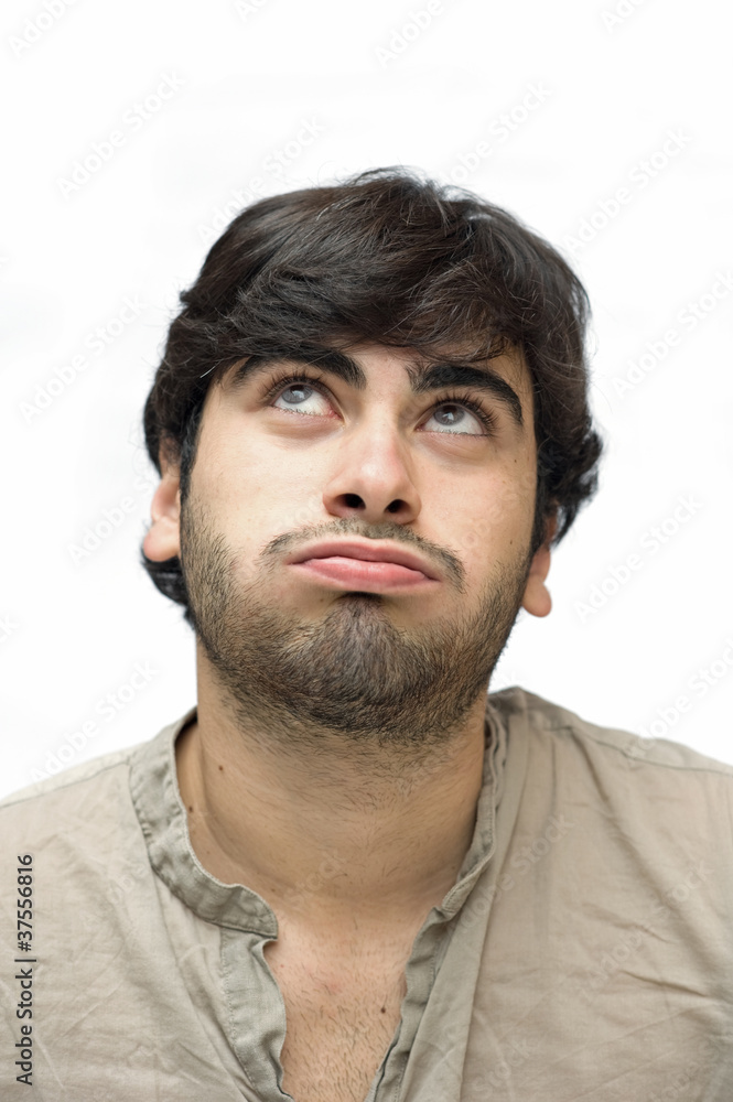 Fototapeta premium Casual man looking up over white background.