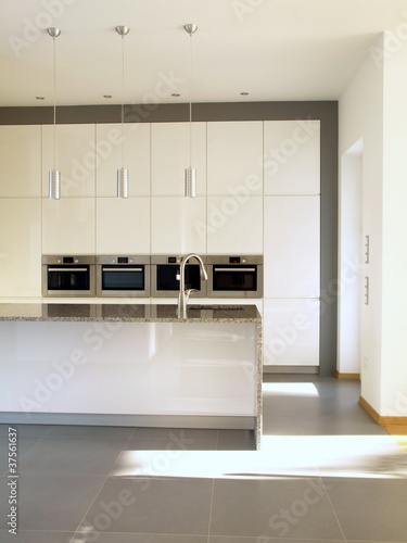 Fototapeta Naklejka Na Ścianę i Meble -  Modern minimalist buil-in kitchen in white