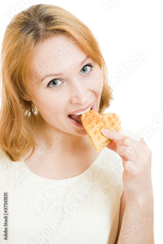 Woman eating cookies in a heart-shaped.