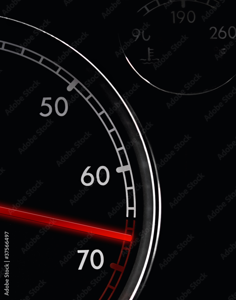Car tachometer, dash board close up, red arrow in a red zone Car tachometer, dash board close up, red arrow in a red zone