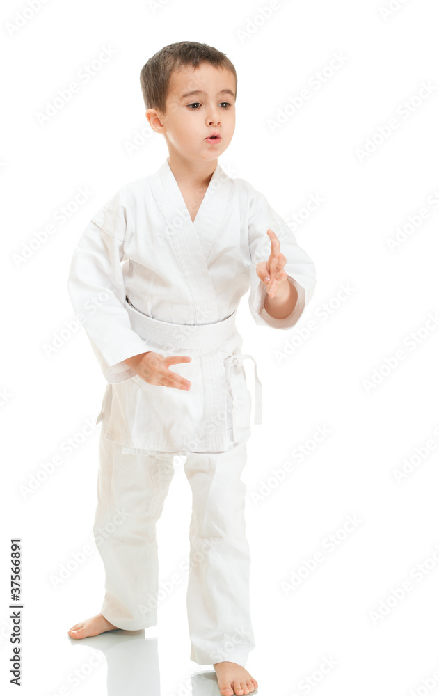 Aikido boy fighting position in white kimono Aikido boy fighting position in white kimono
