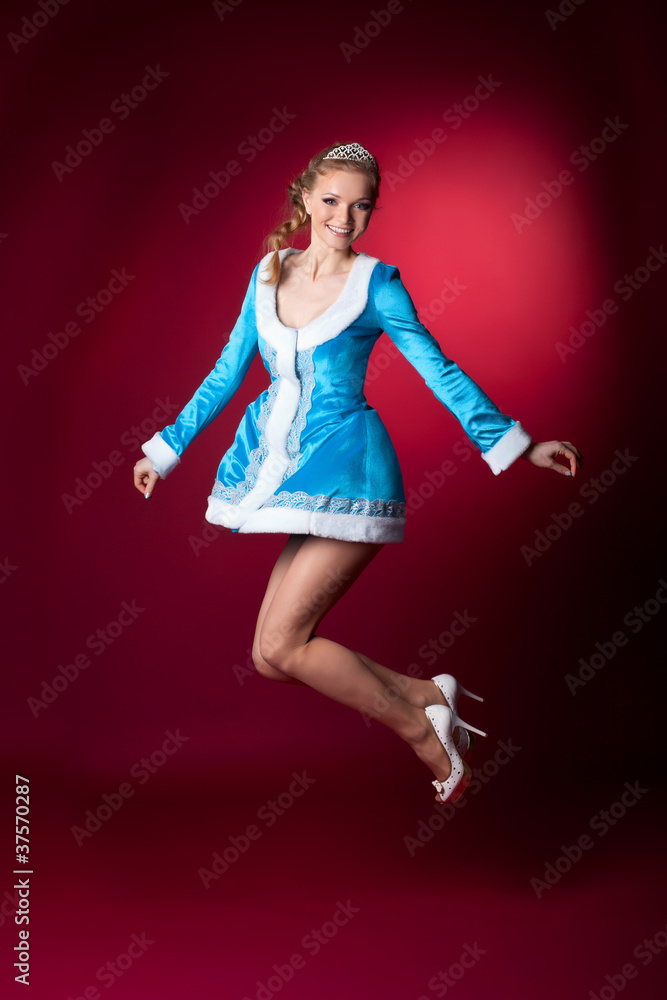 Sexy blond christmas girl in blue jump on red Sexy blond christmas girl in blue jump on red