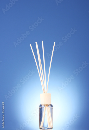 Bottle of air freshener on blue background