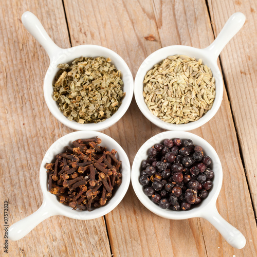 Assorted bowls of spices over wooden table