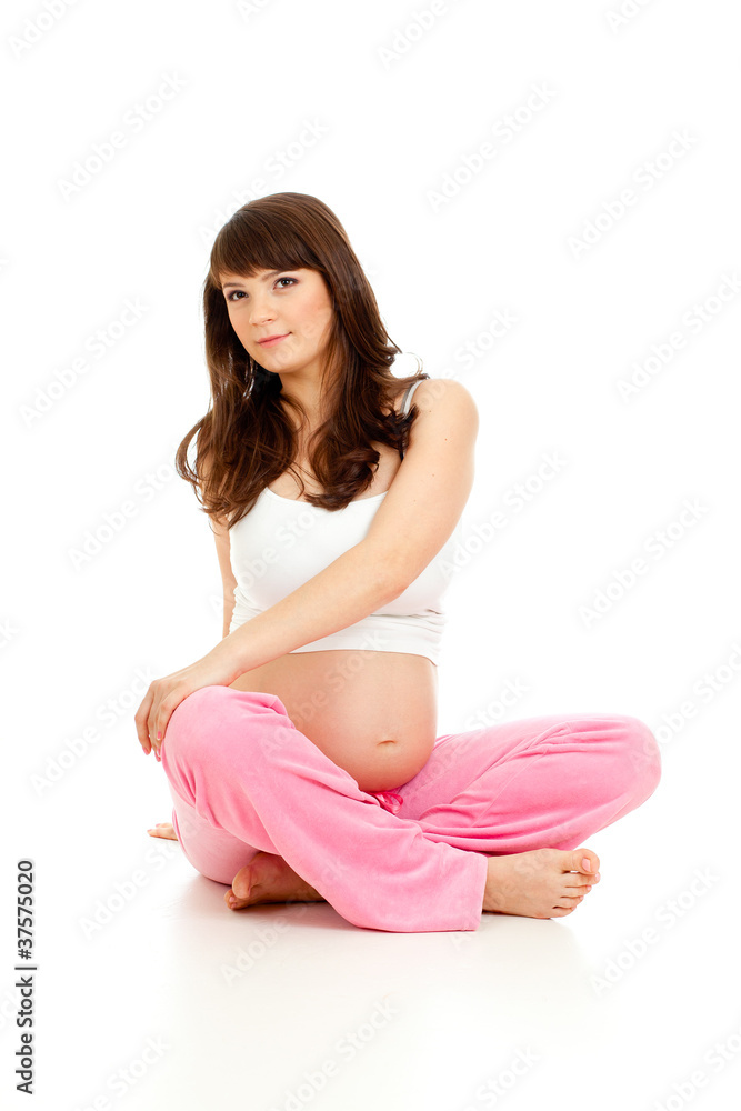 Pregnant woman doing gymnastic exercises isolated on white Pregnant woman doing gymnastic exercises isolated on white