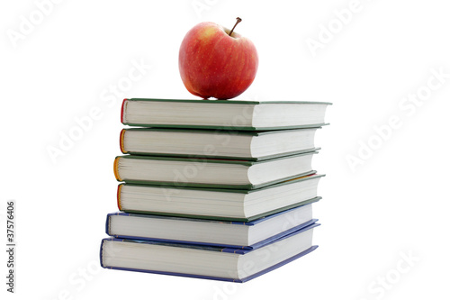 apple on pile of books isolated on white
