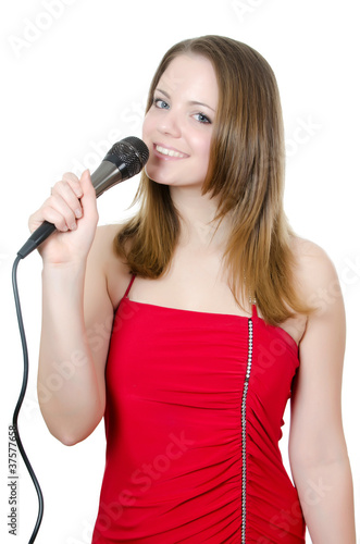 Girl with a microphone isolated on white