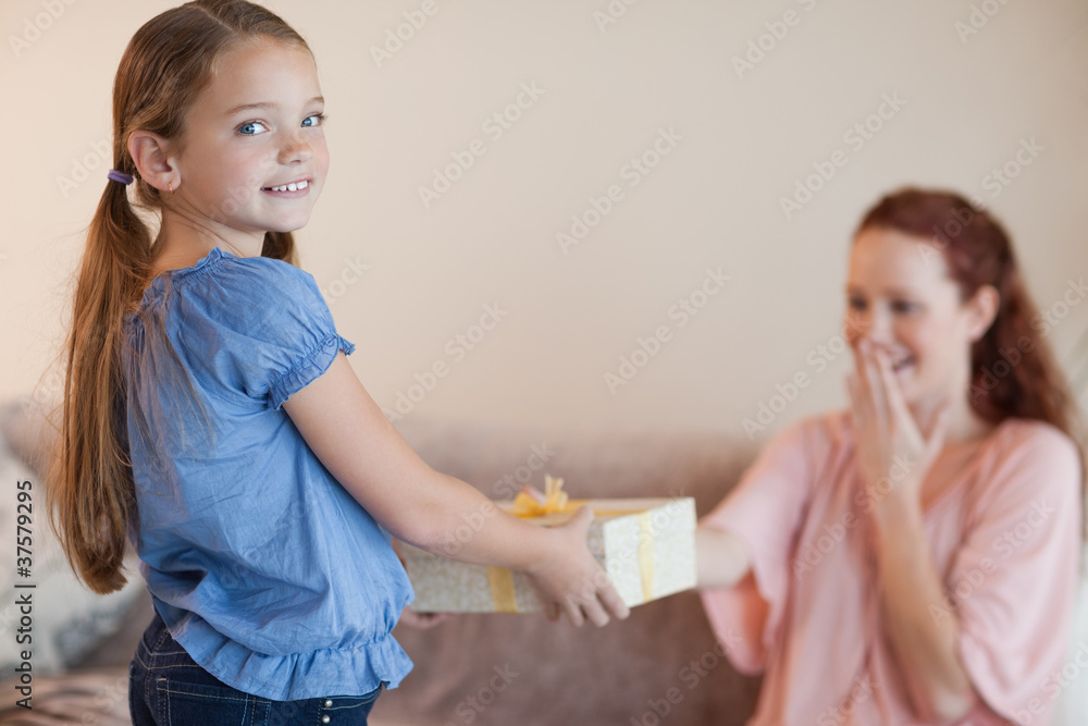 Girl giving her mother a present Girl giving her mother a present