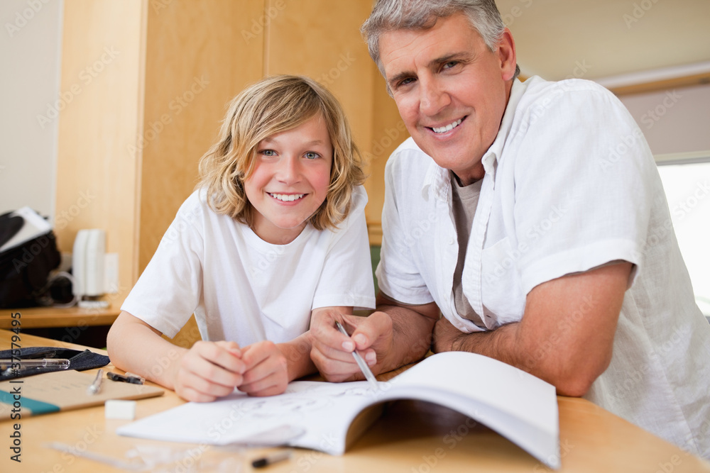 Father helping son with his homework Father helping son with his homework