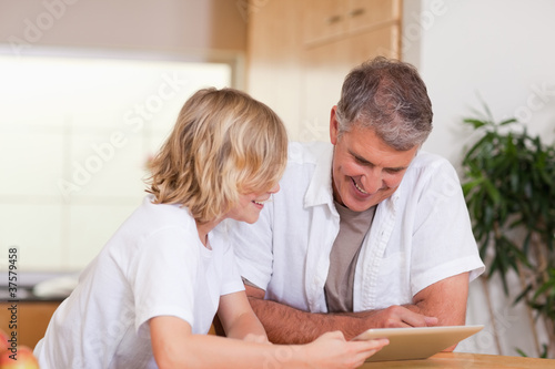 Father and son using tablet