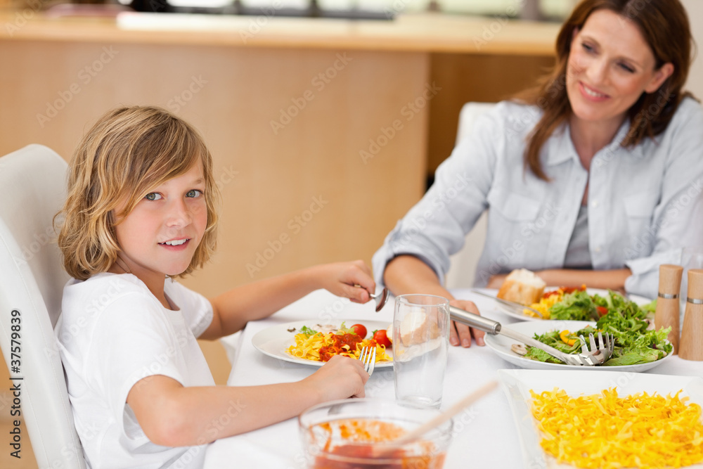 Side view of boy sitting at the dinner table