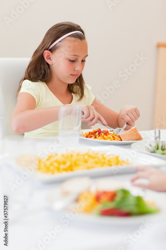 Girl eating at dinner table
