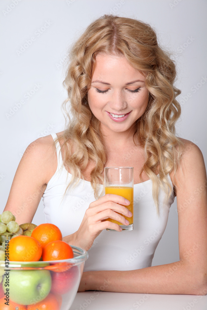 Beautiful blond woman drinking fruit juice Beautiful blond woman drinking fruit juice