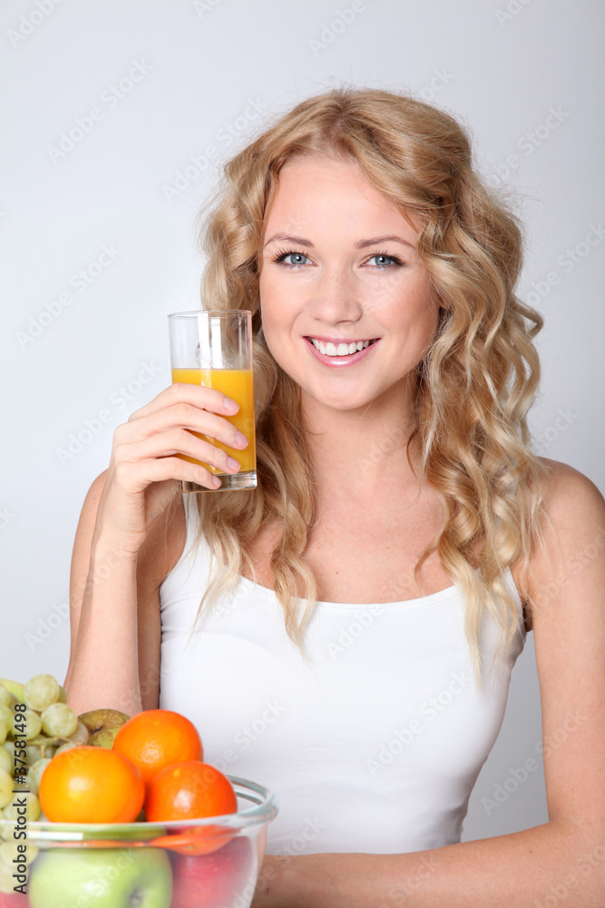 Beautiful blond woman drinking fruit juice Beautiful blond woman drinking fruit juice