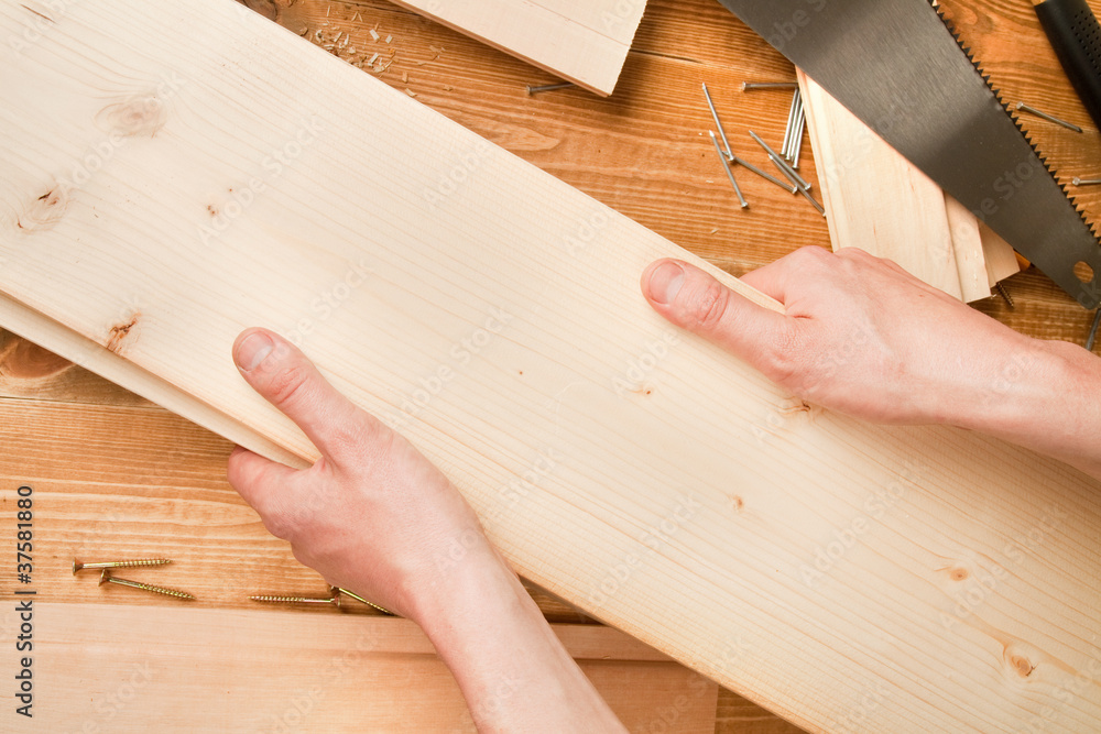 Man's hands holding planks Man's hands holding planks