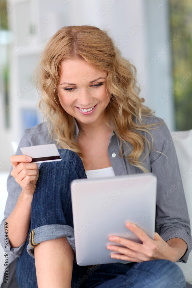 Fototapeta premium Blond woman doing online shopping with digital tablet