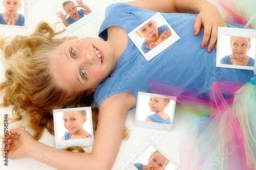 Beautiful Young Girl Child in TuTu on Floor with Photographs