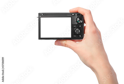 Hand holding digital camera rear view. Empty space for your pict