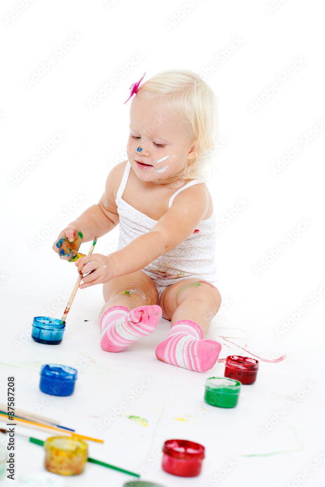 little girl bedaubed with bright colors little girl bedaubed with bright colors