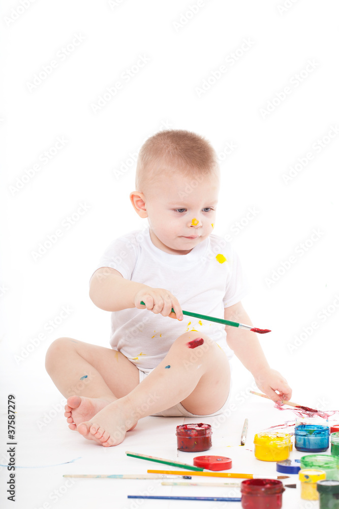 boy bedaubed with bright colors boy bedaubed with bright colors