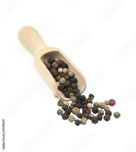 black peppercorns on a wooden spoon