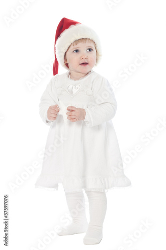 The baby girl in santa's hat with a toy