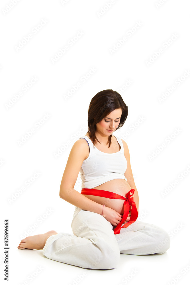 Brunette pregnant woman with red ribbon isolated on white Brunette pregnant woman with red ribbon isolated on white
