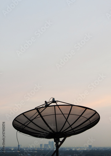 Satellite dish in sunset sky