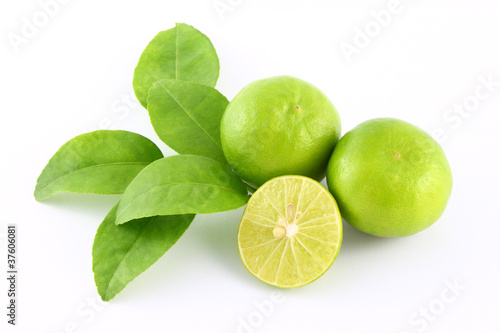Limes fruit and leaf on white background.
