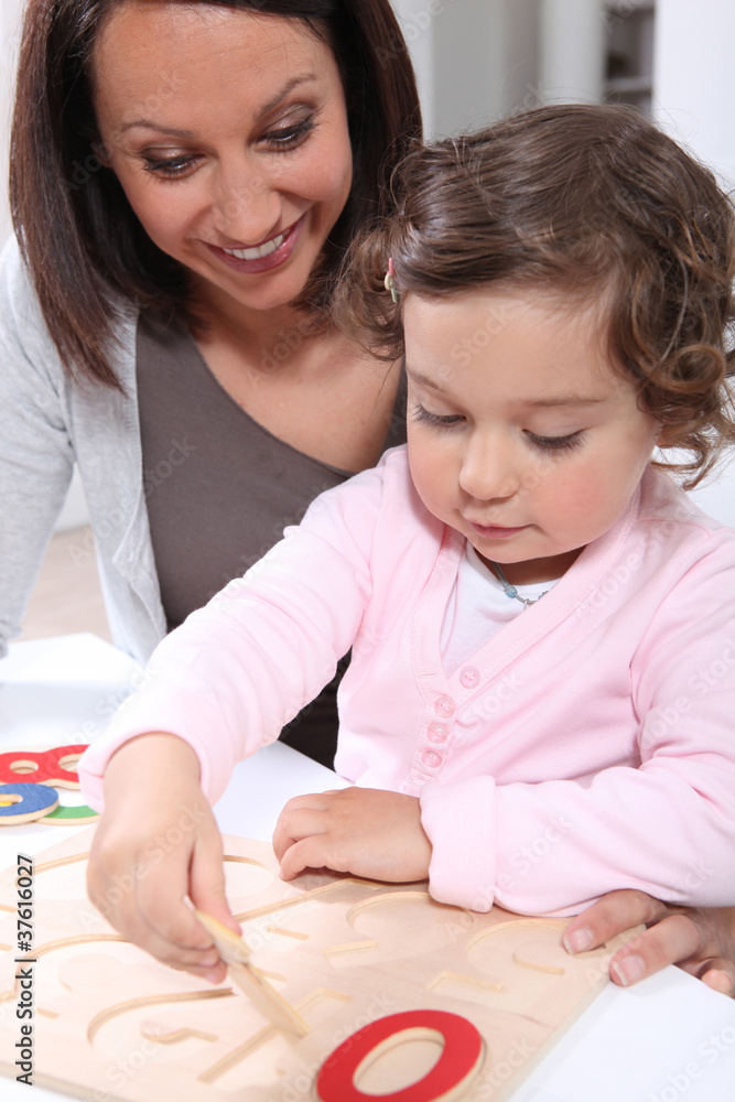 Mother and daughter doing a wooden