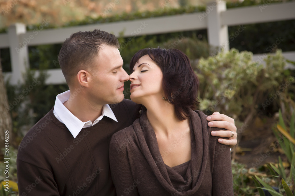 Attractive Couple Kissing in the Park Attractive Couple Kissing in the Park