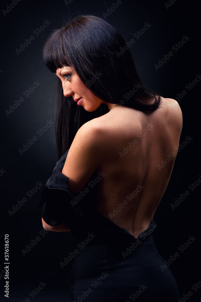 Beautiful elegant woman in black dress indoors Beautiful elegant woman in black dress indoors