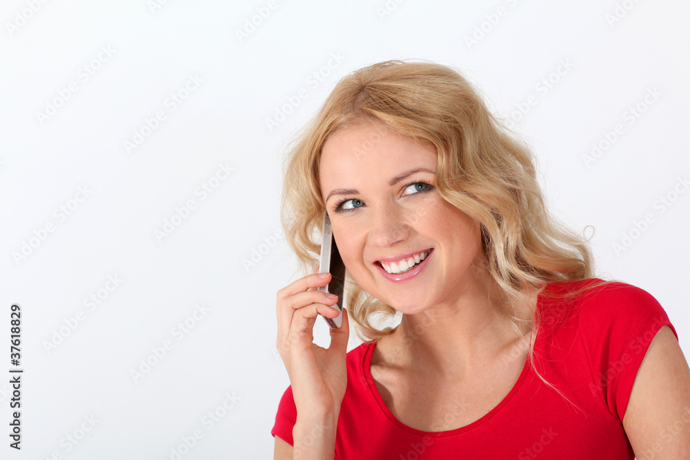 Portrait of blond woman with red shirt using mobile phone