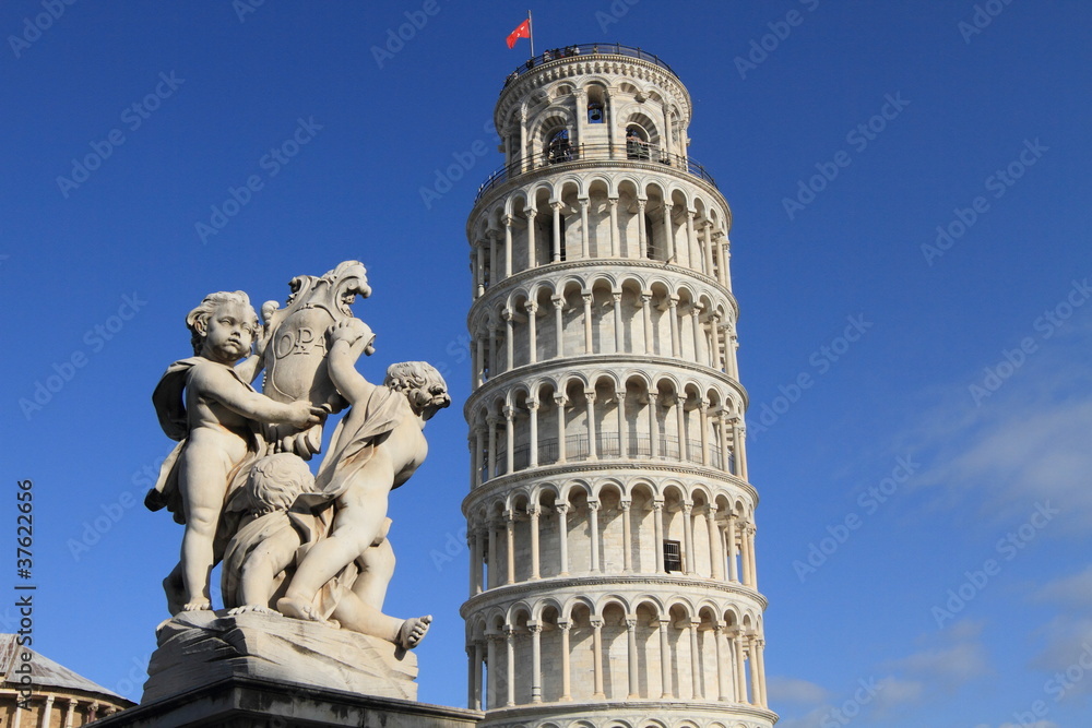 Pisa leaning tower and statue of angels, Italy