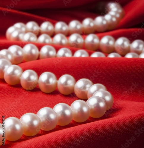Pearl necklace on luxury satin background