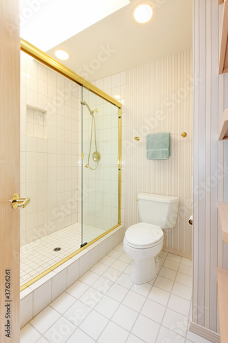 Bathroom with white tiles and glass shower