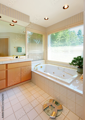 Nice bathroom with white tub and ceramic tiles.