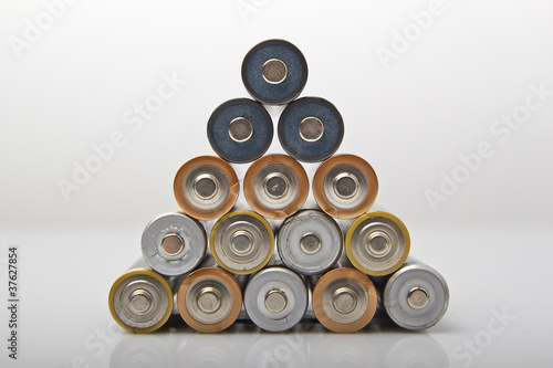 used and new various AA batteries stacked in pyramid shape