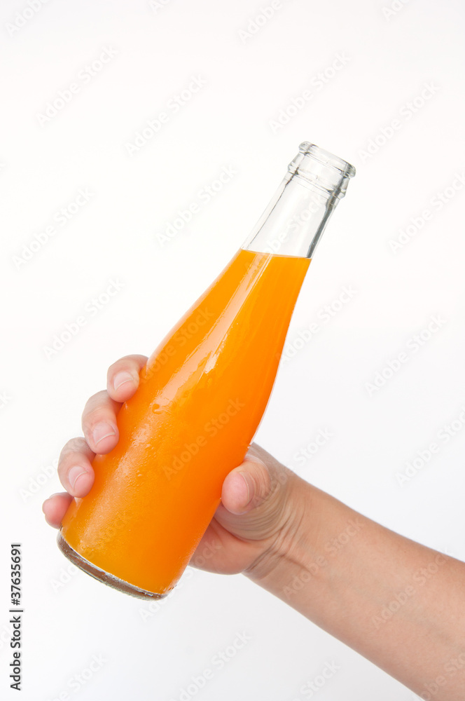 orange juice bottle in hand isolated on white background