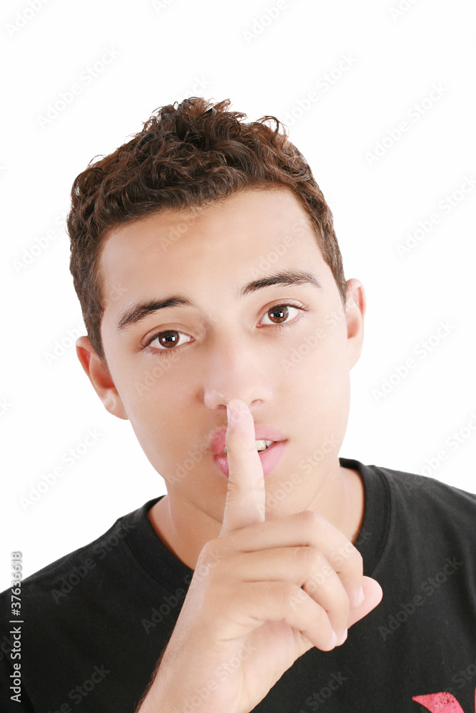 young man with finger on his mouth isolated over white backgroun young man with finger on his mouth isolated over white backgroun