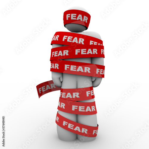 Scared Afraid Man Wrapped in Red Fear Tape photo