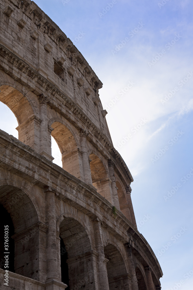 light shining through colosseum  in rome
