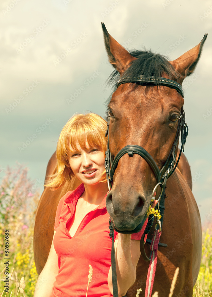 Obraz premium young pretty girl with her horse