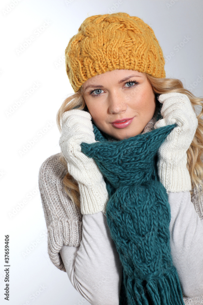 Portrait of woman on white background wearing woolen accessories Portrait of woman on white background wearing woolen accessories